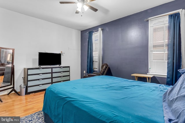 bedroom with a ceiling fan and wood finished floors