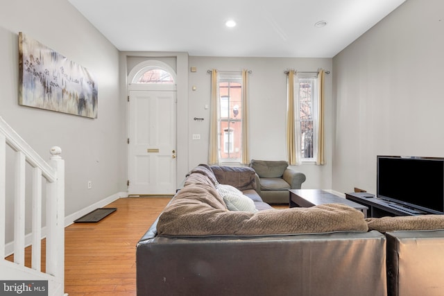 living area featuring stairs, baseboards, wood finished floors, and recessed lighting