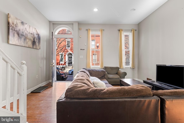 living room with stairway, recessed lighting, wood finished floors, and baseboards