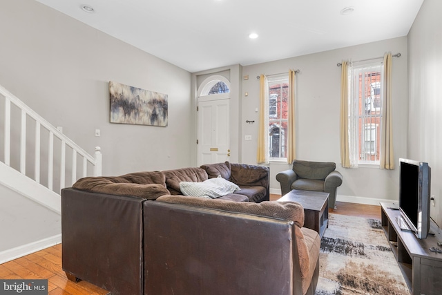 living area with stairs, light wood finished floors, recessed lighting, and baseboards