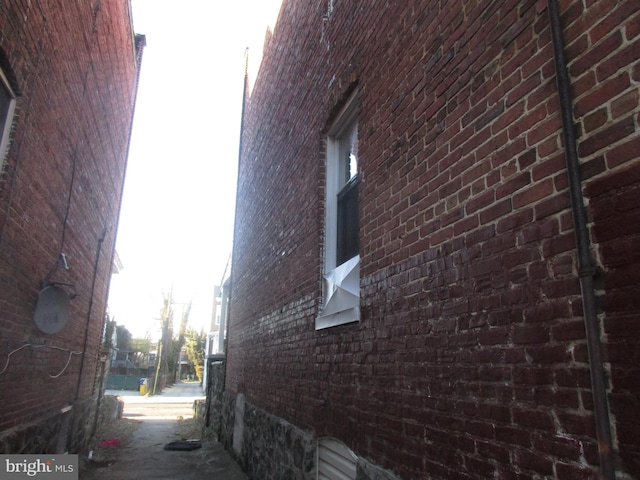 view of side of home featuring brick siding