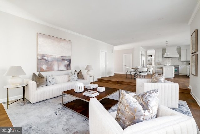 living area featuring ornamental molding, baseboards, and dark wood-style flooring