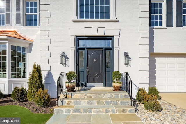 doorway to property featuring brick siding