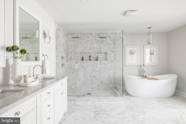 bathroom featuring a shower stall, a freestanding bath, and vanity