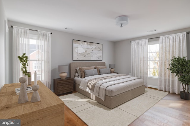 bedroom with wood finished floors and visible vents