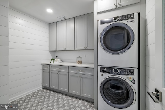 washroom featuring light floors, visible vents, laundry area, recessed lighting, and stacked washer / dryer