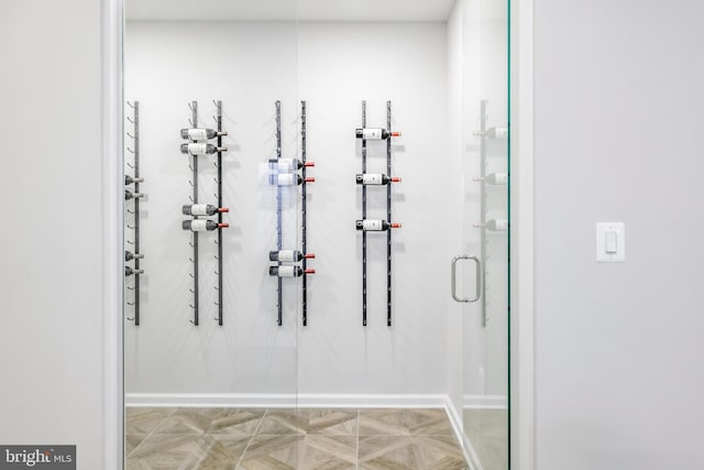 bathroom featuring a stall shower and baseboards