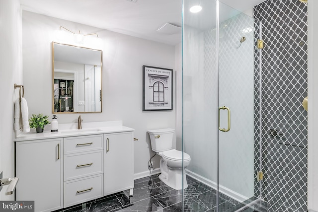 full bath featuring toilet, marble finish floor, a shower stall, baseboards, and vanity