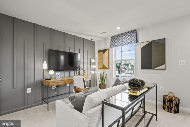 carpeted living area with visible vents and baseboards