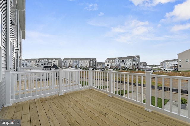 wooden terrace featuring a residential view