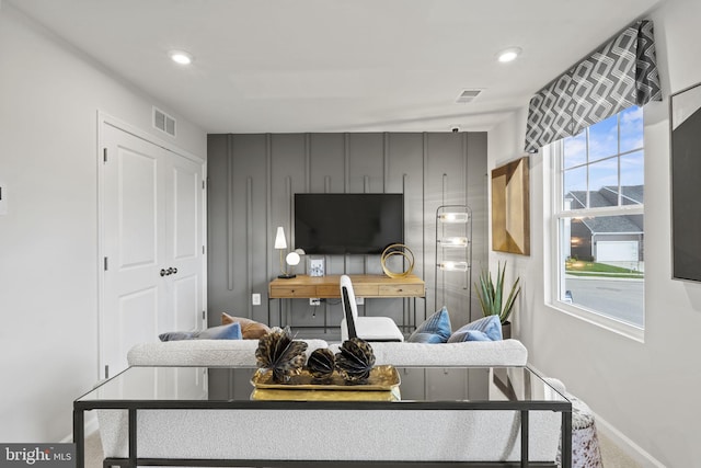 living room featuring baseboards, visible vents, and recessed lighting