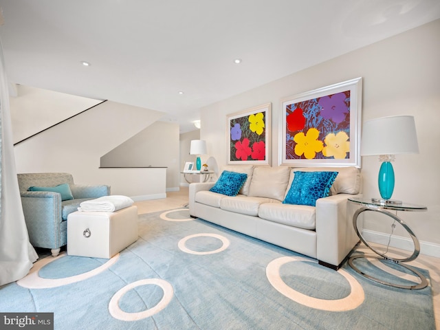 living area featuring recessed lighting and baseboards