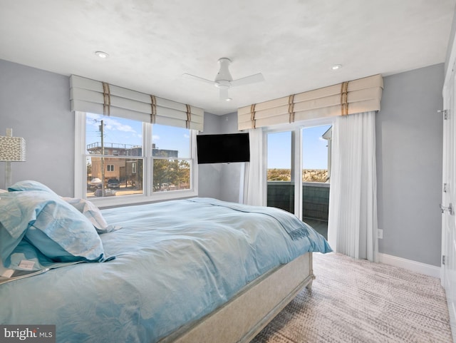 bedroom with access to exterior, multiple windows, ceiling fan, and baseboards