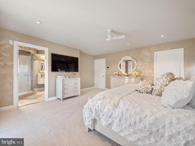 bedroom with recessed lighting, light colored carpet, ensuite bath, and baseboards