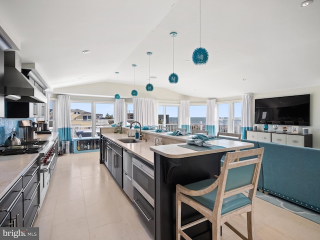 kitchen featuring lofted ceiling, plenty of natural light, light countertops, and a sink