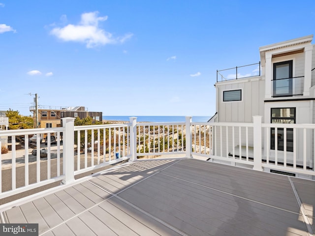 wooden deck featuring a water view