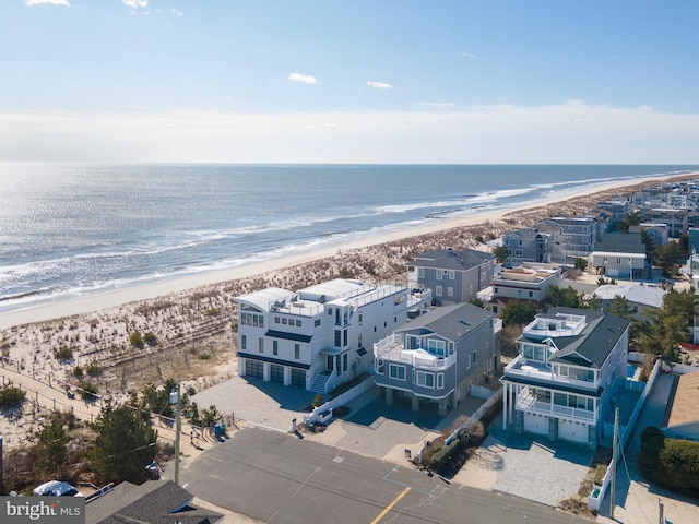 drone / aerial view with a water view and a view of the beach