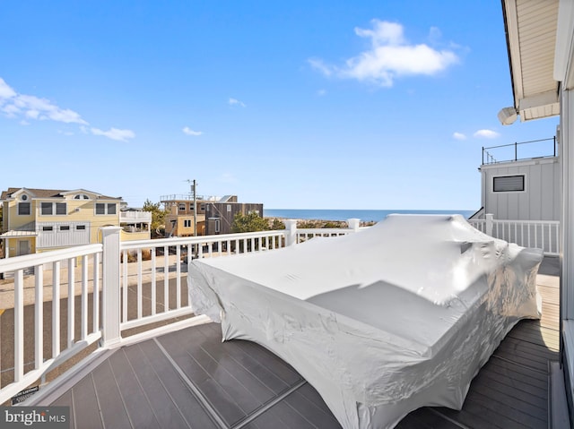 wooden terrace featuring a water view