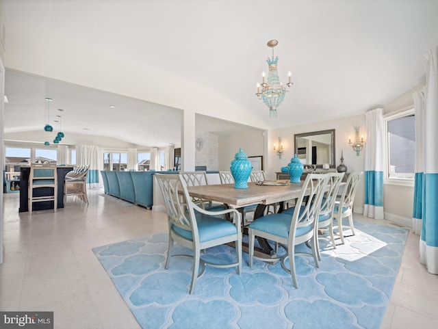 dining space with light tile patterned floors, baseboards, a chandelier, and vaulted ceiling