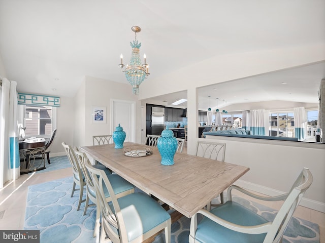 dining area featuring vaulted ceiling, a wealth of natural light, and baseboards