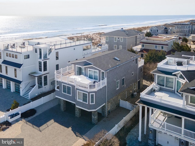 drone / aerial view with a water view, a view of the beach, and a residential view