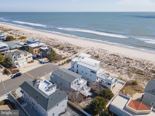 drone / aerial view featuring a water view and a beach view