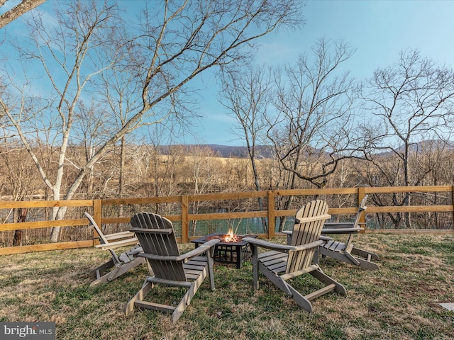 view of yard with a fire pit and fence