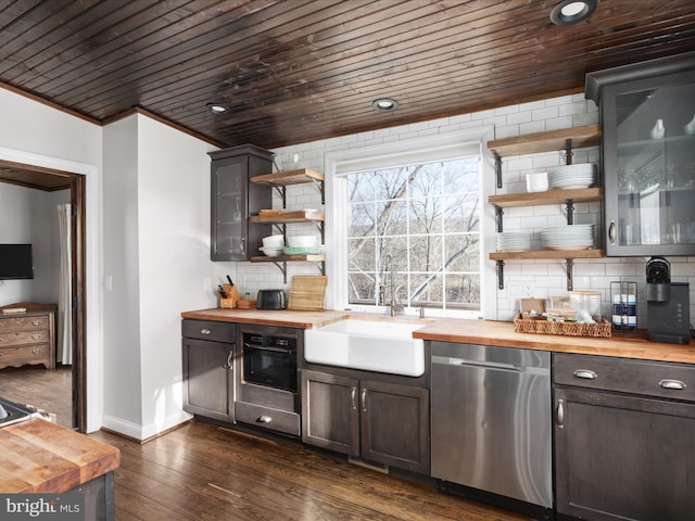 kitchen featuring open shelves, tasteful backsplash, wooden counters, a sink, and dishwasher