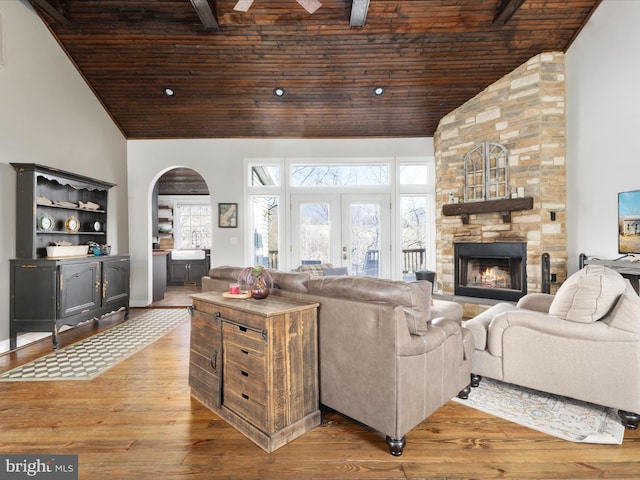 living room with high vaulted ceiling, hardwood / wood-style flooring, and wood ceiling