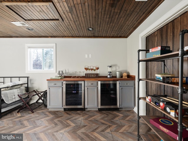 bar featuring a bar, wood ceiling, wine cooler, and visible vents