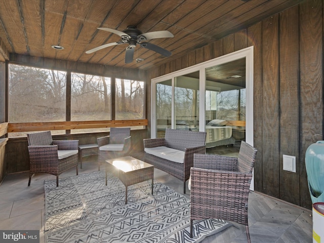 sunroom / solarium featuring wooden ceiling and a ceiling fan