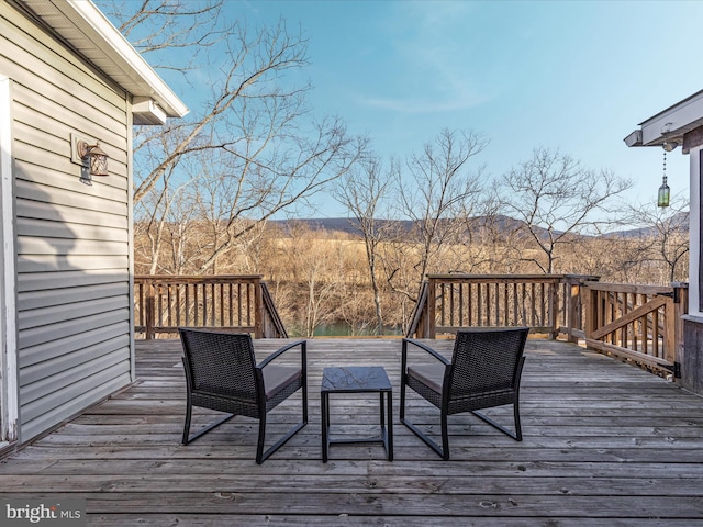 wooden deck with a mountain view