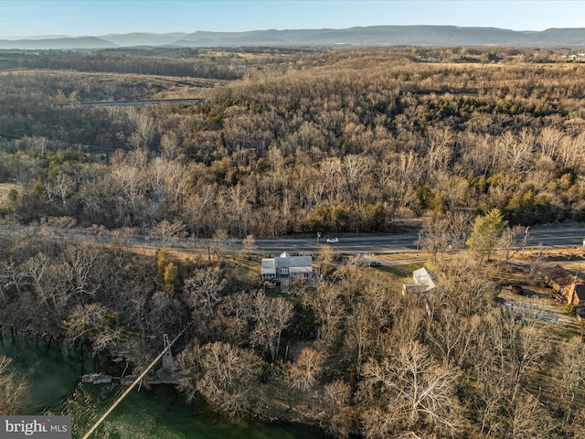 birds eye view of property featuring a mountain view and a wooded view