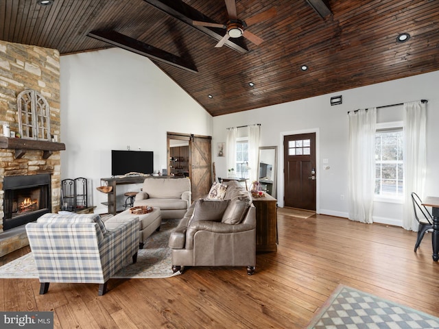 living area with high vaulted ceiling, wood ceiling, hardwood / wood-style floors, and a barn door