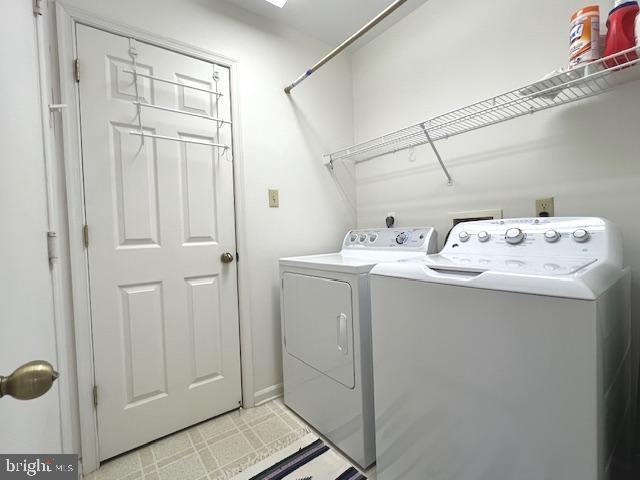 washroom featuring washer and dryer and laundry area