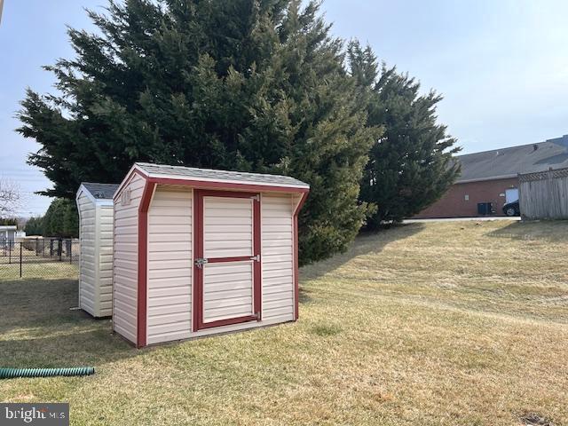 view of shed featuring fence