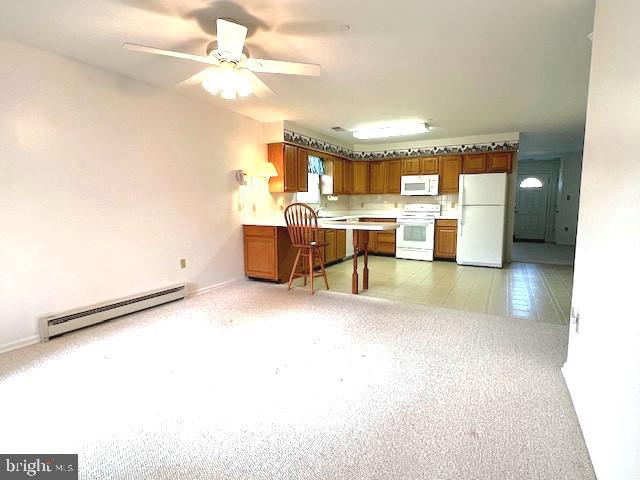 kitchen featuring a baseboard radiator, light countertops, brown cabinetry, ceiling fan, and white appliances