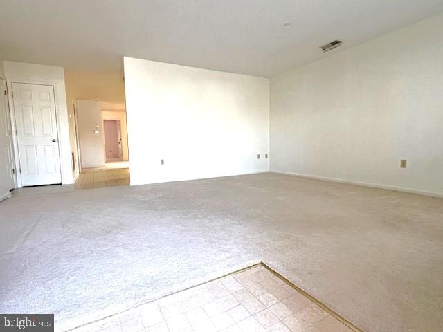 unfurnished room with carpet floors and visible vents