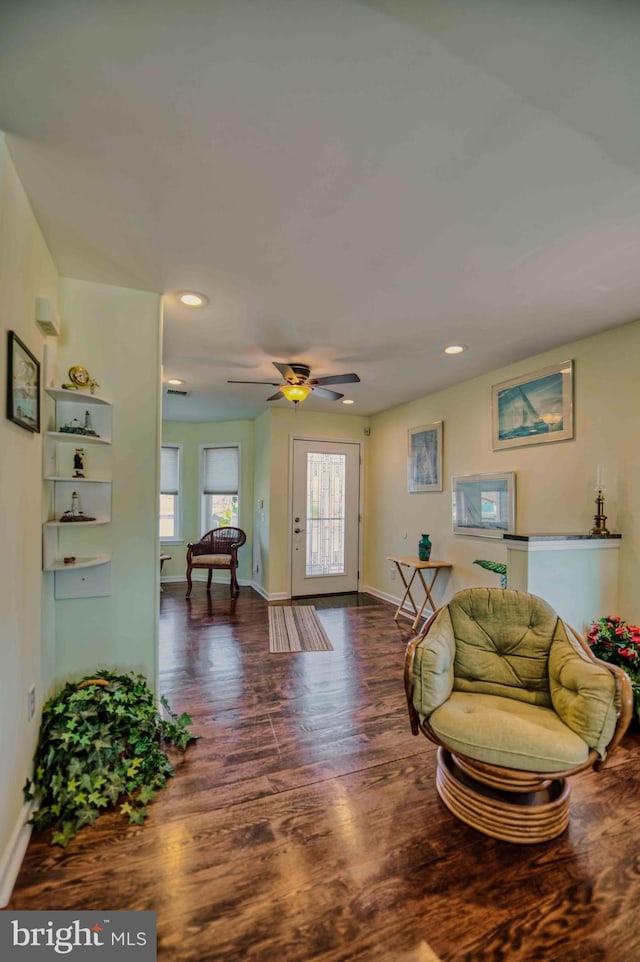 interior space with a ceiling fan, recessed lighting, baseboards, and wood finished floors