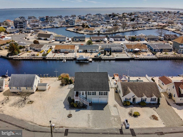 drone / aerial view featuring a water view and a residential view