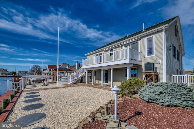 exterior space featuring a deck, stairway, and fence