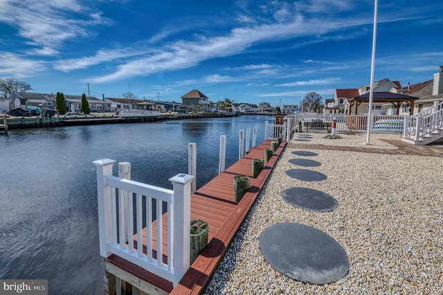 dock area featuring a water view and a residential view