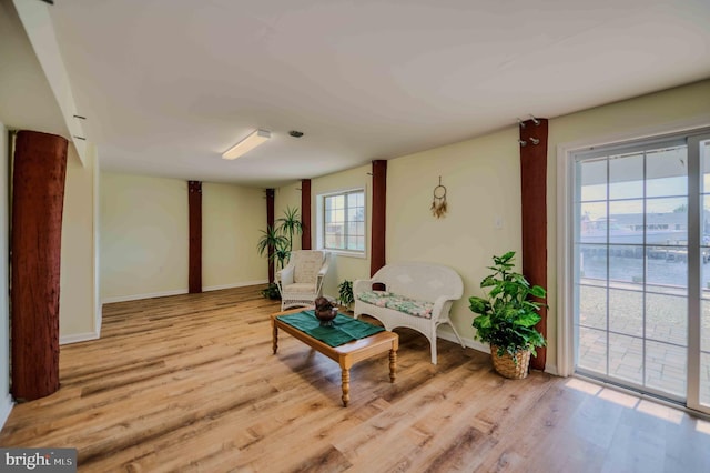 sitting room with baseboards and wood finished floors