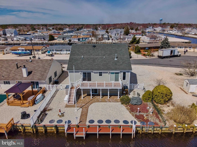 drone / aerial view with a water view and a residential view