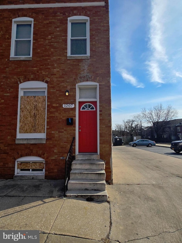 view of front of property with entry steps and brick siding