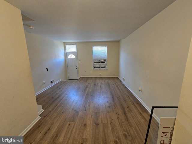 entryway featuring visible vents, baseboards, and wood finished floors