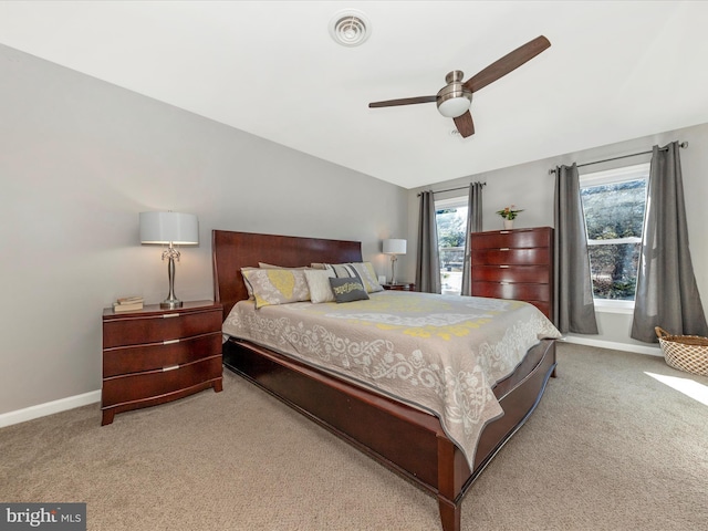 carpeted bedroom featuring visible vents, a ceiling fan, baseboards, and vaulted ceiling