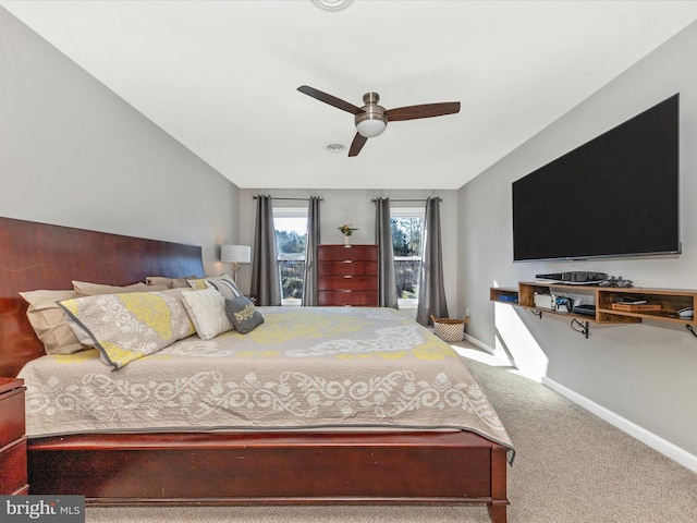 carpeted bedroom with a ceiling fan, lofted ceiling, and baseboards