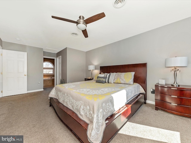 bedroom featuring visible vents, ceiling fan, baseboards, carpet, and ensuite bathroom