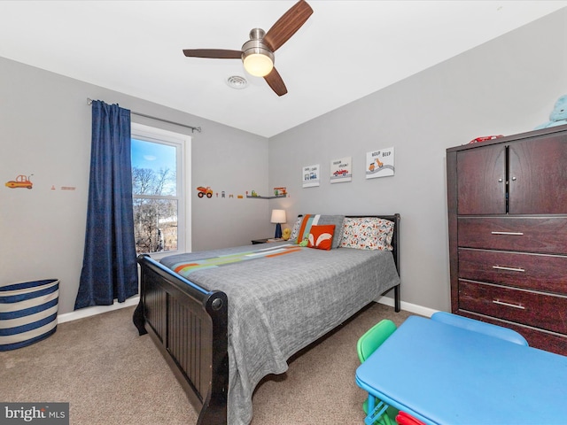 bedroom with visible vents, baseboards, light colored carpet, and ceiling fan